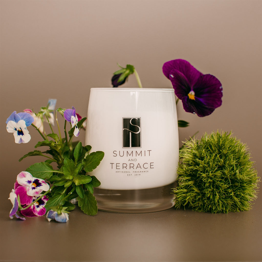 Fiori Muse Classic Candle in white glass vessel with notes of geranium, rose, and patchouli—bright and romantic for everyday home use.
