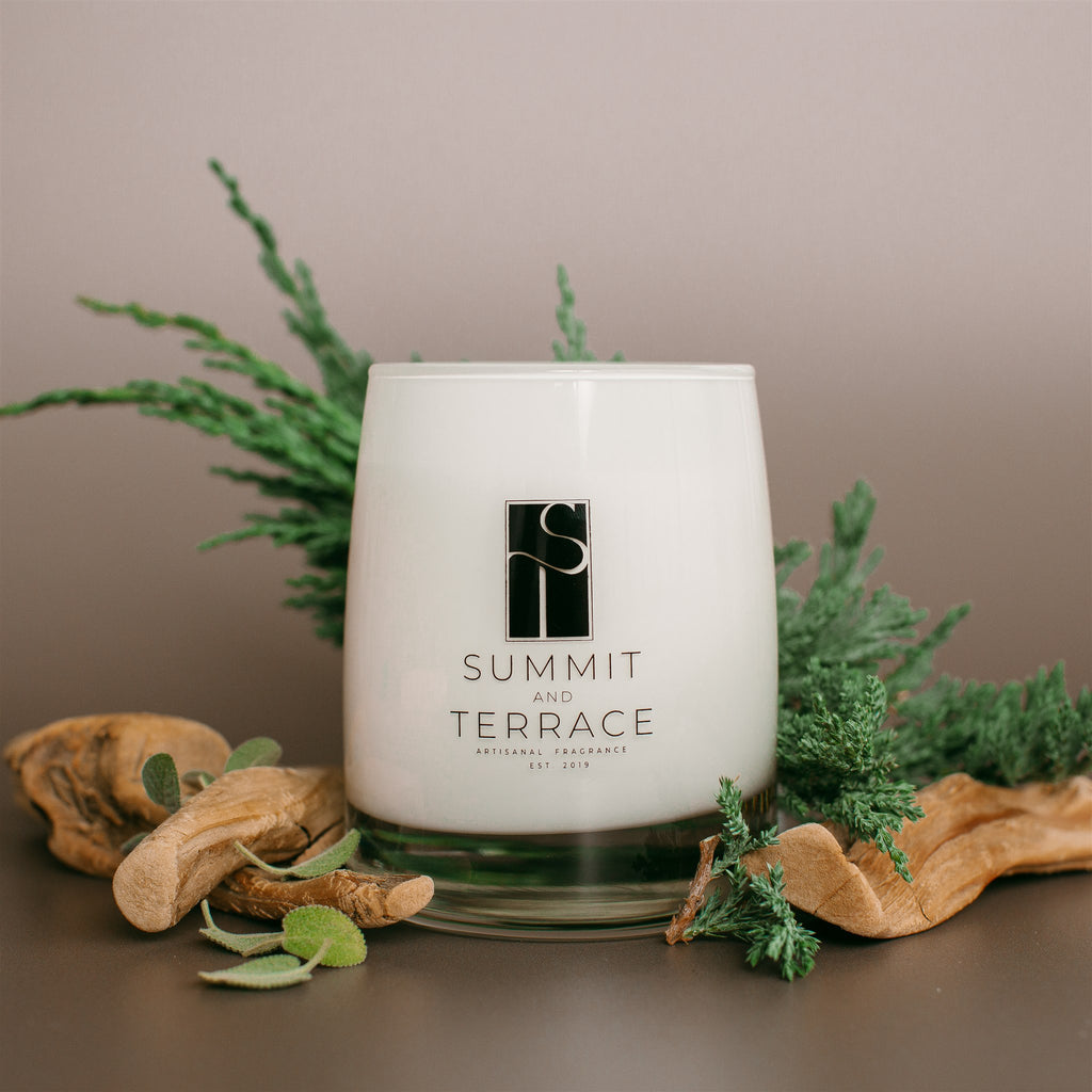 Margaux Muse Classic Candle in white glass vessel with notes of bergamot, cypress, and driftwood—light, fresh, and ideal for any room.
